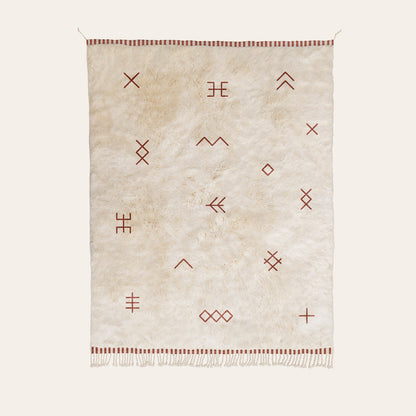 Natural wool rug with geometric patterns in maroon on a white background